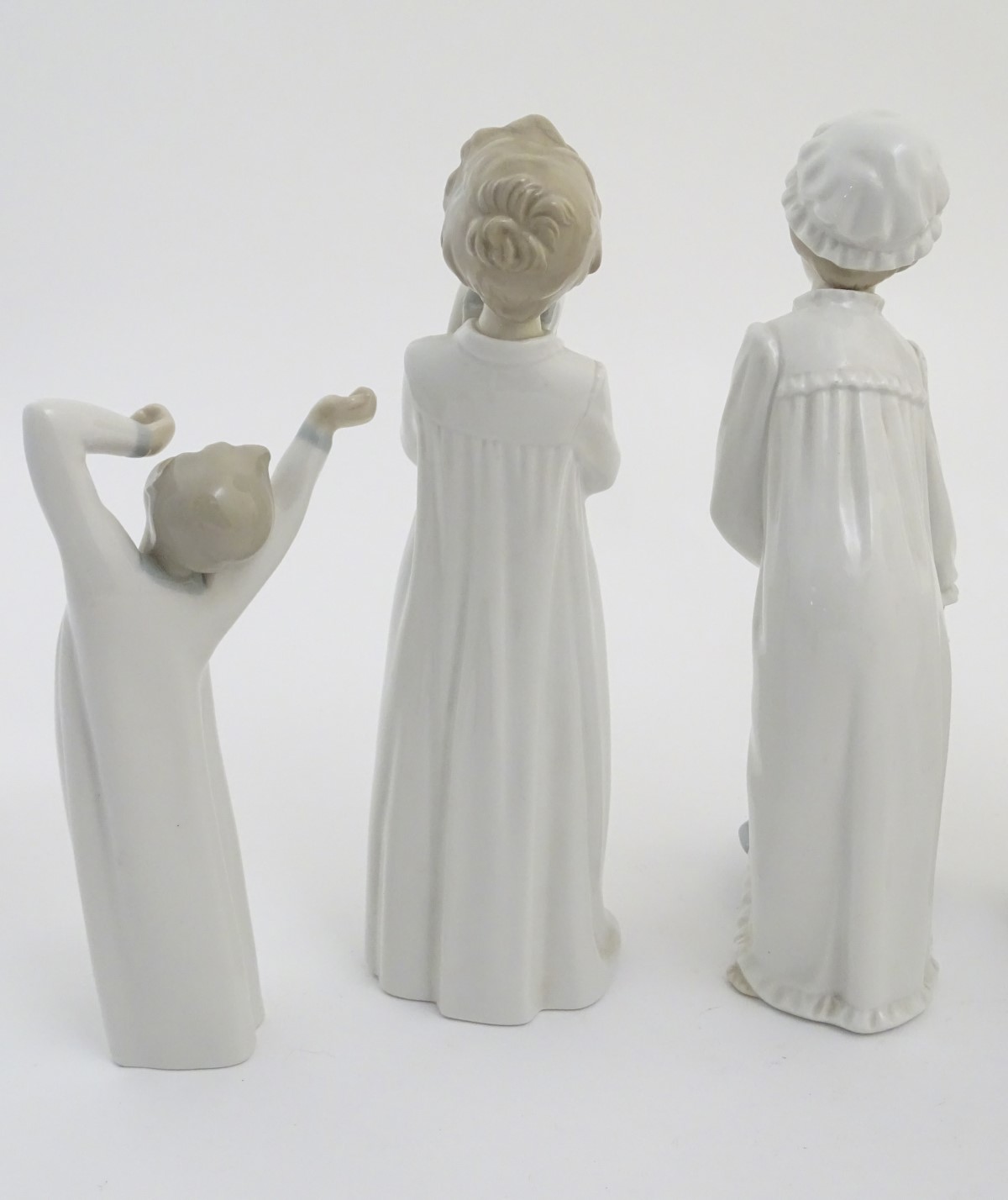 Four Nao figures to include 'Boy with Slippers', model no. 232, 'Boy with Books', model no. - Image 7 of 12