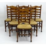 A set of six oak 20thC ladder back dining chairs,