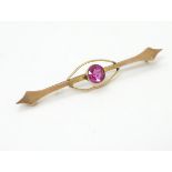 A late 19thC / early 20thC 9ct gold bar brooch set with pink tourmaline.