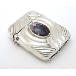 A silver vesta case converted to a lighter and with later applied cabochon depicting Winston