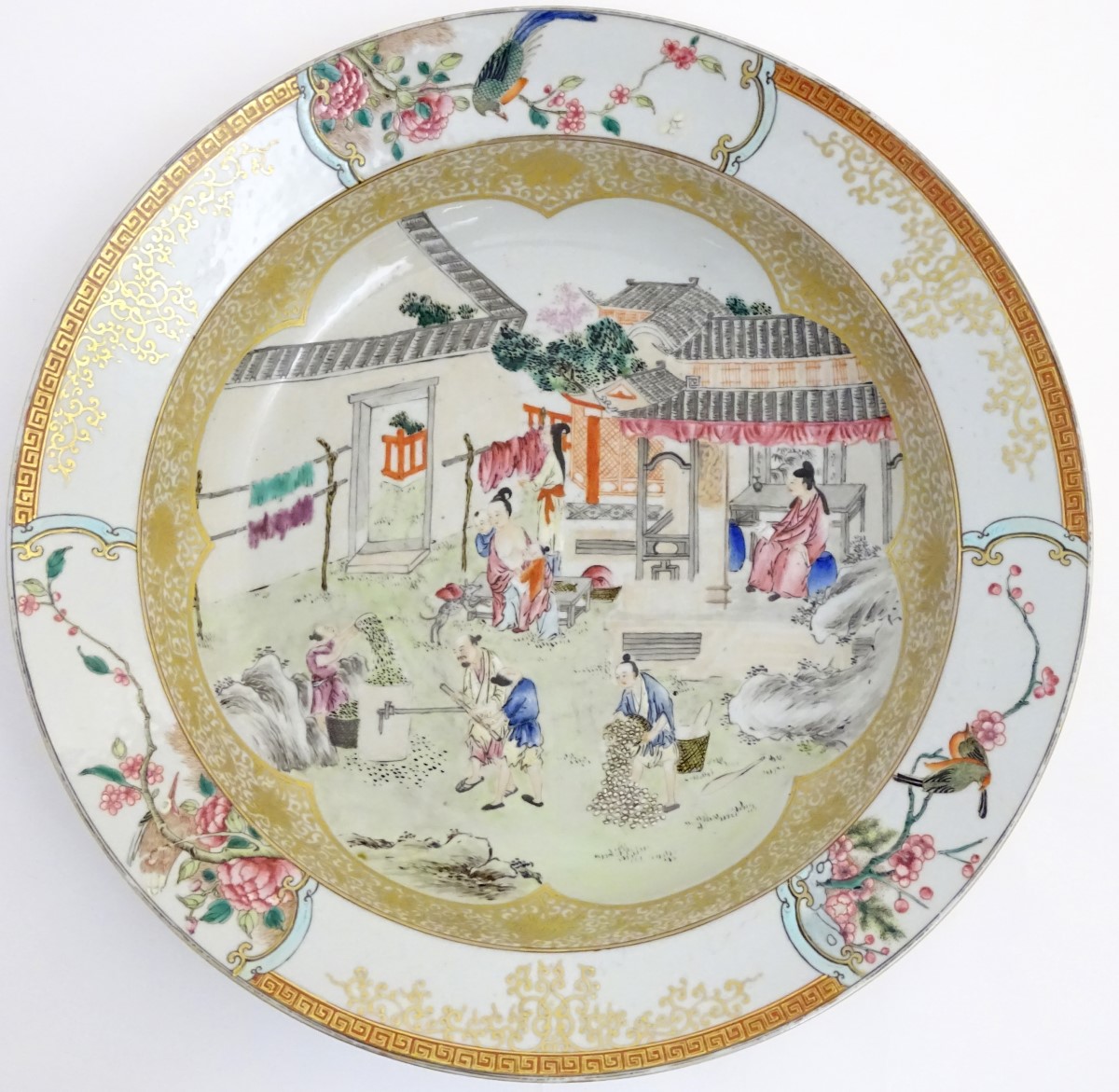 A large Chinese bowl with hand painted scenes of rural life, including a mother and child,