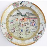 A large Chinese bowl with hand painted scenes of rural life, including a mother and child,