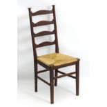 An Arts and Crafts ladder back chair with an envelope rush seat and standing on tapering squared