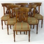 A set of six mahogany Scandinavian dining chairs with curved back rests and carved backsplats,