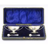 A cased pair of silver pedestal table salts. Hallmarked Birmingham 1909 maker J Sherwood & Sons.