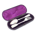 A cased Victorian silver Christening set comprising fork and spoon with engraved decoration.