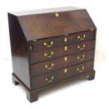 A late 18thC mahogany bureau with fall front containing pigeon holes and small drawers,