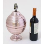 A 1960s lamp of anodised aluminium with a pink/bright copper colour finish, 12 1/2" high.