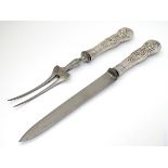 Carving knife and fork with white metal Queens pattern handles.