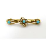 A c1900 gold and gilt metal brooch set with turquoise and seed pearls.