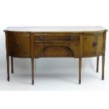 An early 20thC mahogany bow fronted sideboard,