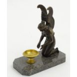 Regency patinated bronze An angel kneeling before a gilded pedestal bowl,
