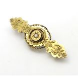 A Victorian 15ct gold brooch set with central pearl.