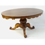 A mid 19thC mahogany dining table / breakfast table with an oval top having hanging decorative