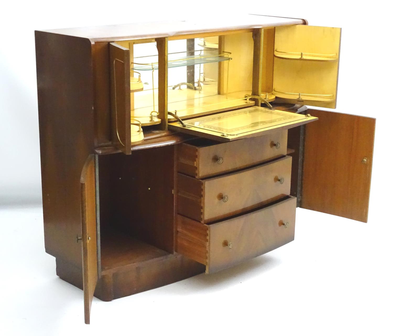 A 1930’s walnut cocktail cabinet, the top opening to reveal fitted shelves and a mirrored back. - Image 8 of 12