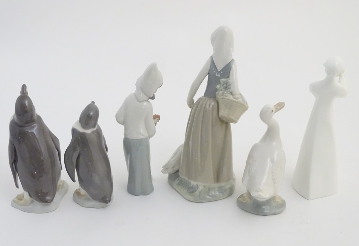 A quantity of Lladro and Nao figures, to include two Lladro penguins and girl holding a chicken, - Image 2 of 11