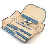 A 1950s manicure set in a folding silk lined turquoise leather wallet. 6 5/8” wide.