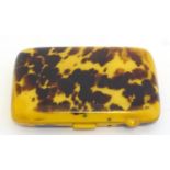 A faux blonde tortoiseshell Bakelite 1920s cigarette case, 3 3/8" wide.