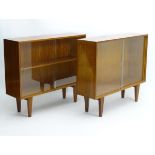 Vintage Retro - a pair of English mid 20 thC 'Gordon Russell' Walnut low bookcases with sliding