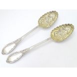 A pair of embossed silver berry spoons hallmarked Sheffield 1906 maker Mappin & Webb Ltd.