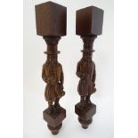 A pair of Dutch carved cabinet columns in the form of hat wearing figures,