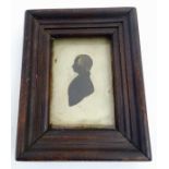 A 19thC gilt highlighted miniature silhouette portrait of a man. Approx.