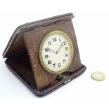 A 1920s crocodile skin travelling clock: a 2 1/2”, 8 day Swiss timepiece,