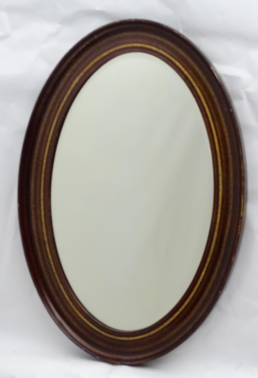 A mid 20thC oval bevelled mirror with crossbanded detailing to the frame. - Image 4 of 10