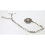A silver watch chain with ornate Victorian silver fob .
