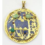 An Oriental lapiz lazuli pendant set with jade, ruby, amethyst within a 14k gold mount.
