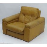 A mid / late 20thC tan leather club armchair. 32" long x 17" wide x 27" high.