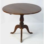 A mid 19thC occasional tripod table with tilt top mechanism,