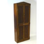 A mid 19thC mahogany ships cabinet with a pointed pediment above four panelled doors and having