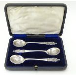 An unusual set of 3 silver apostle spoons the bowls decorated with scenes within a shield cartouche