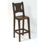A late 19thC oak correctional chair with a pierced back splat,