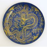 A Chinese dish decorated with a gilt dragon on a blue ground. Approx. 10 1/4" diameter.