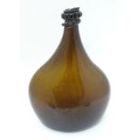 An 18thC Georgian brown glass large bottle with applied top and kick-up under, 12 1/2” high.