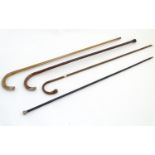 Walking Sticks: A collection of four (3 hallmarked silver and one 9ct gold) mounted canes,