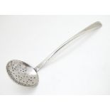 A silver sifter spoon hallmarked London 1991 maker SP.