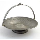 Arts and Crafts : an Armada Pewter cake basket with swing over handle having plannished / hammered