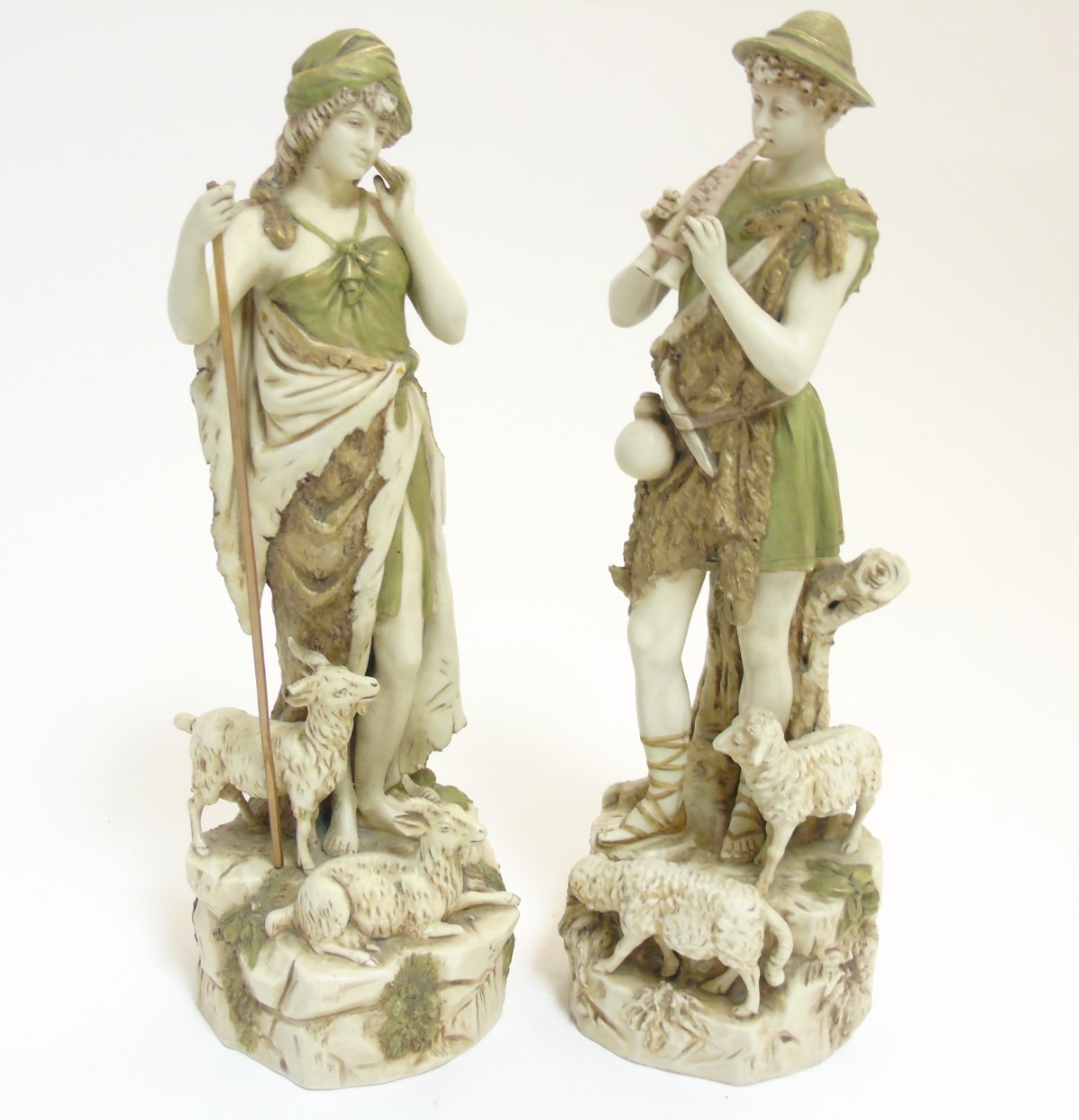 A pair of early 20thC Royal Dux Bohemia figures comprising a shepherd playing the flute and a