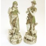 A pair of early 20thC Royal Dux Bohemia figures comprising a shepherd playing the flute and a