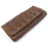An early to mid 20thC crocodile clutch bag with compartments within.