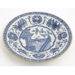 A 19thC Chinese blue and white dish, decorated with auspicious artifacts such as scrolls,