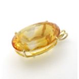 A gold pendant set with large oval yellow citrine 7/8" long CONDITION: Please Note