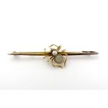 An early 20thC 9ct gold bar brooch with spider decoration to centre set with quartz and pearl.