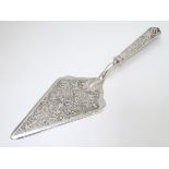 A silver handled pastry server.