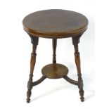 A late 19thC mahogany occasional table with a circular top above three turned tapering legs united