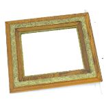 An early / mid 20thC bevelled oak mirror with decorative painted plaster moulding.