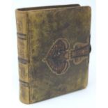 A Victorian/Arts and Crafts photo album with gold tooled and shamrock decoration